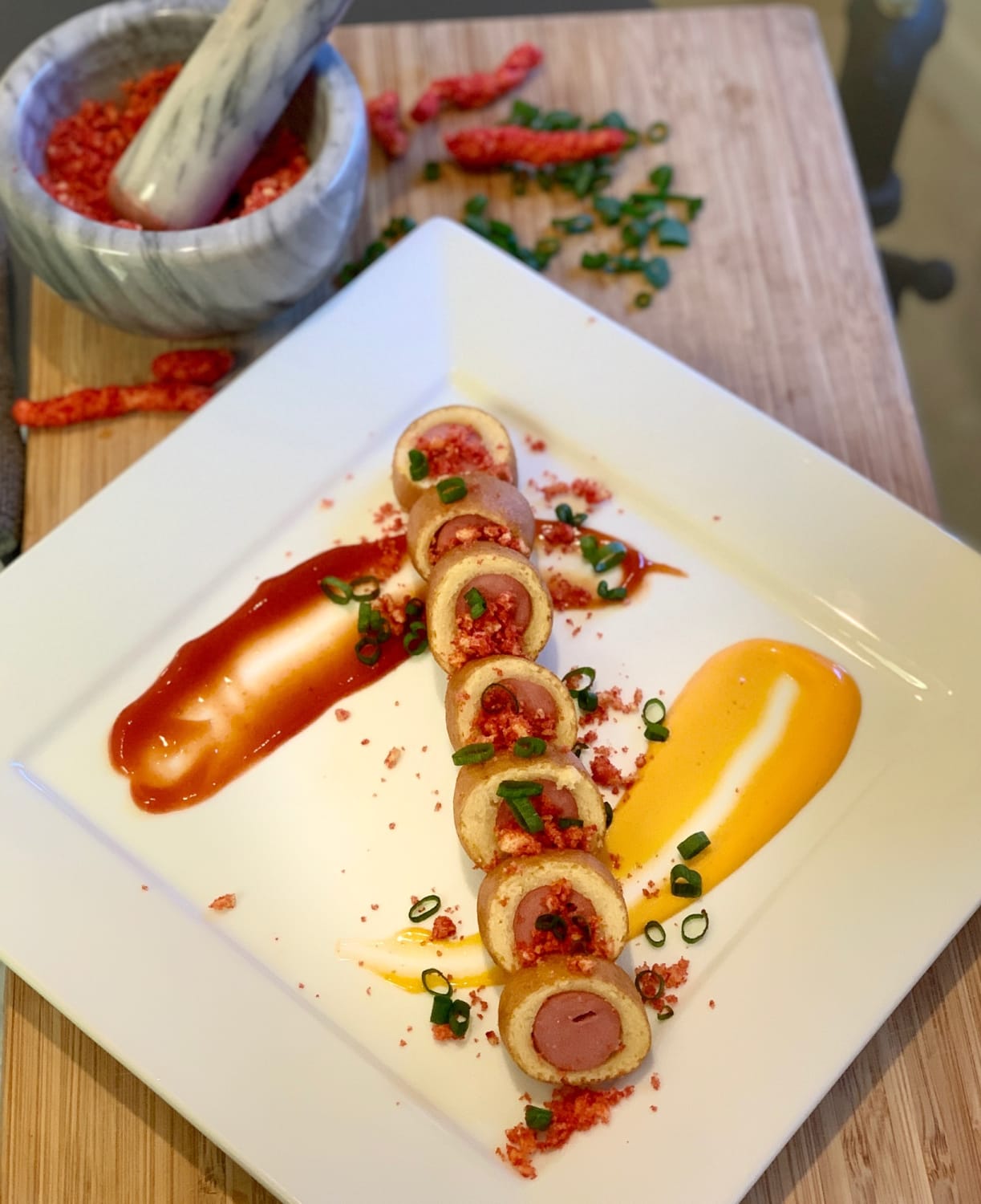 Saucisse de Bœuf Enrobée with roma tomato reduction and a lovely mustard seed aïoli, topped with freshly ground Cheeto poussière and hand picked scallions