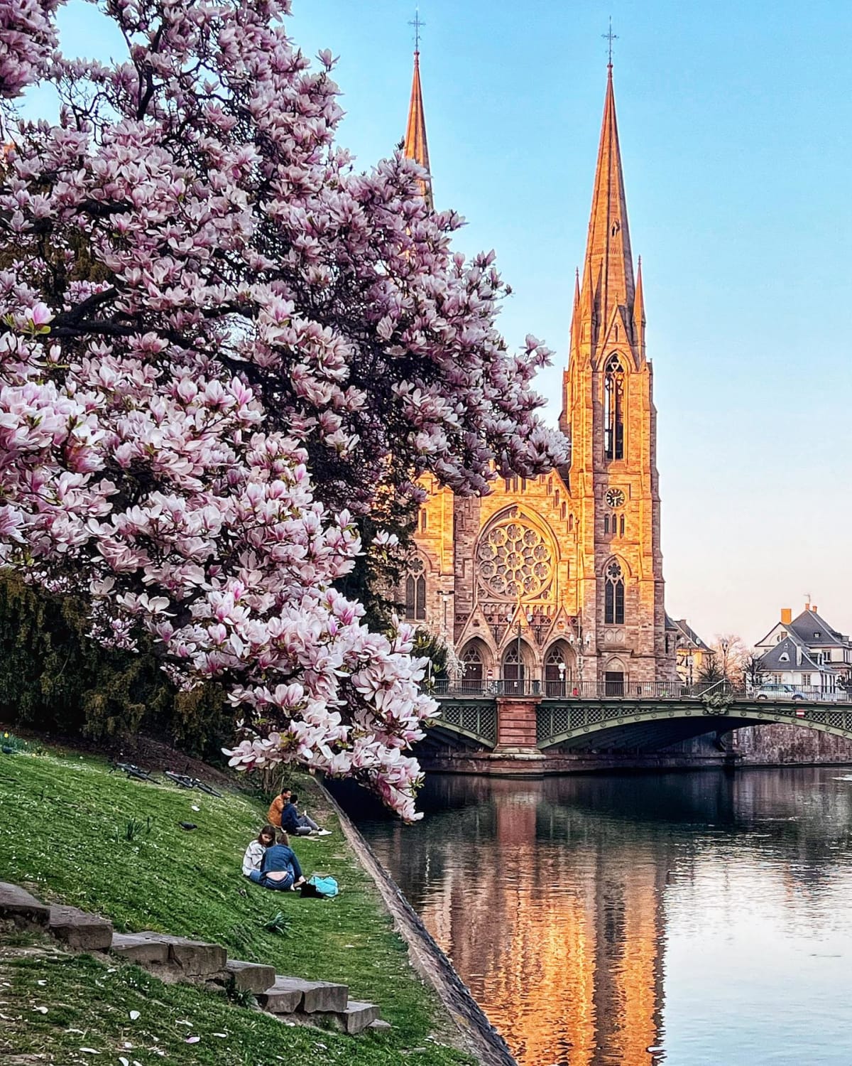 19th century Gothic Revival St. Paul's Church by the Ill River flowing through historic Strasbourg in the Spring, Alsace, Grand Est, eastern France.