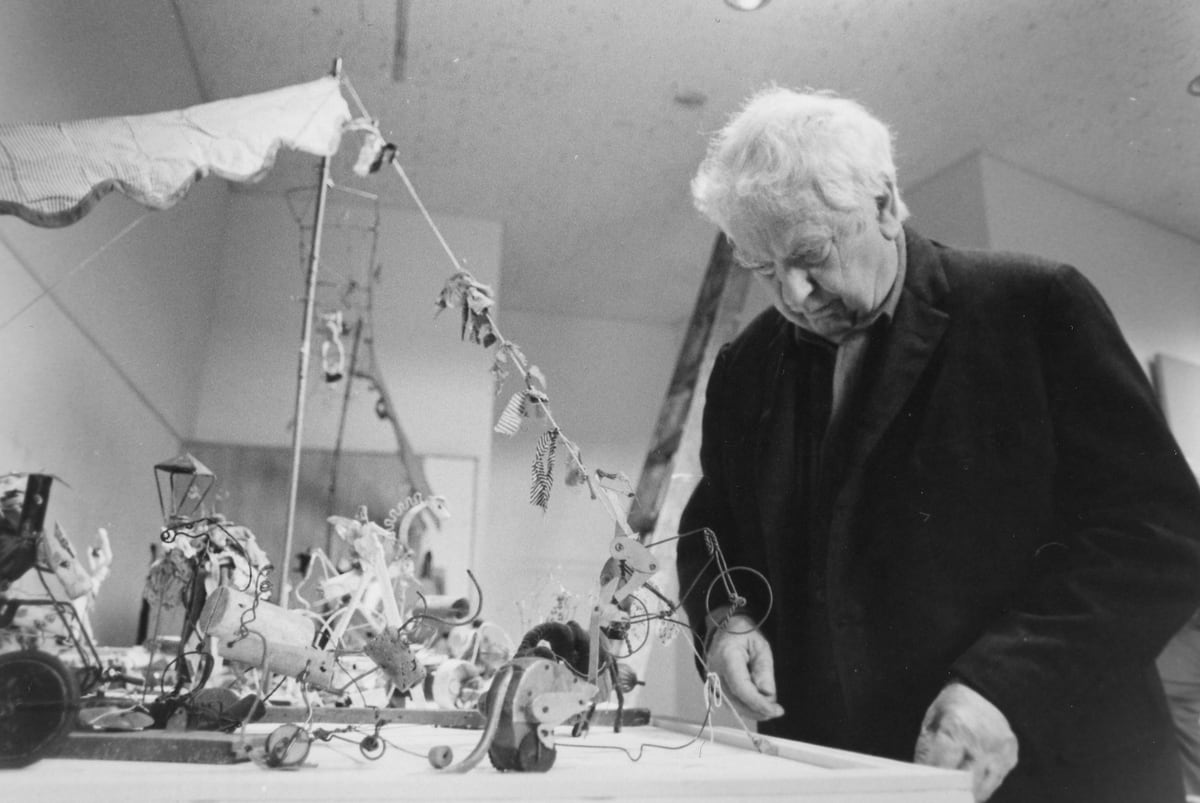 It's a double birthday! Alexander Calder and Edward Hopper were both born on this day. Calder is pictured here unpacking his enchanting Circus, and Hopper is pictured second with Flora Whitney Miller, then-president of the Whitney Museum, in front of Early Sunday Morning.