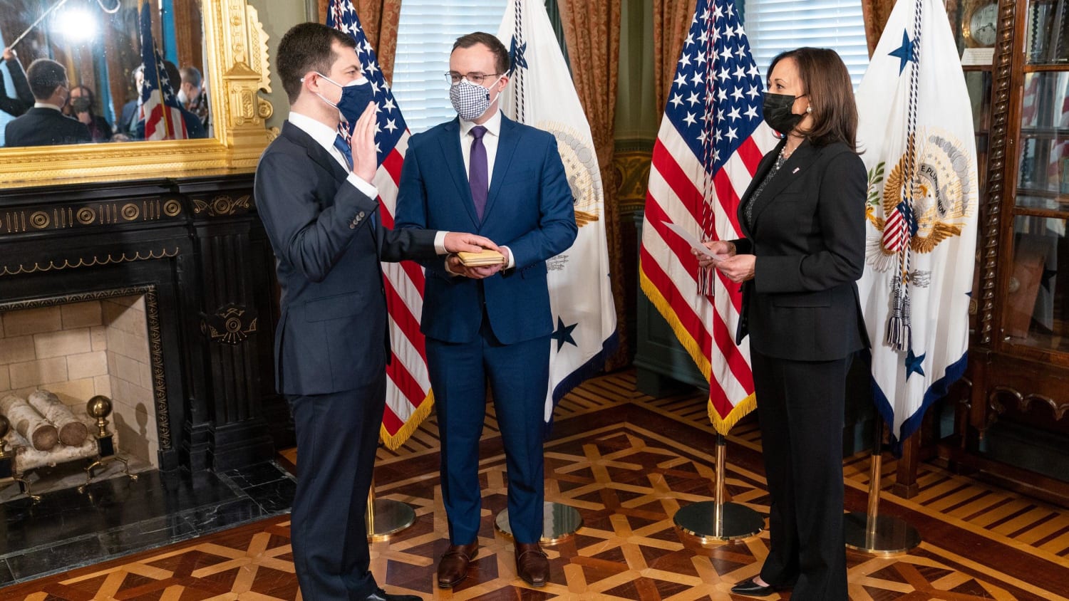 Pete Buttigieg being sworn in as the first openly gay confirmed cabinet member with husband at side