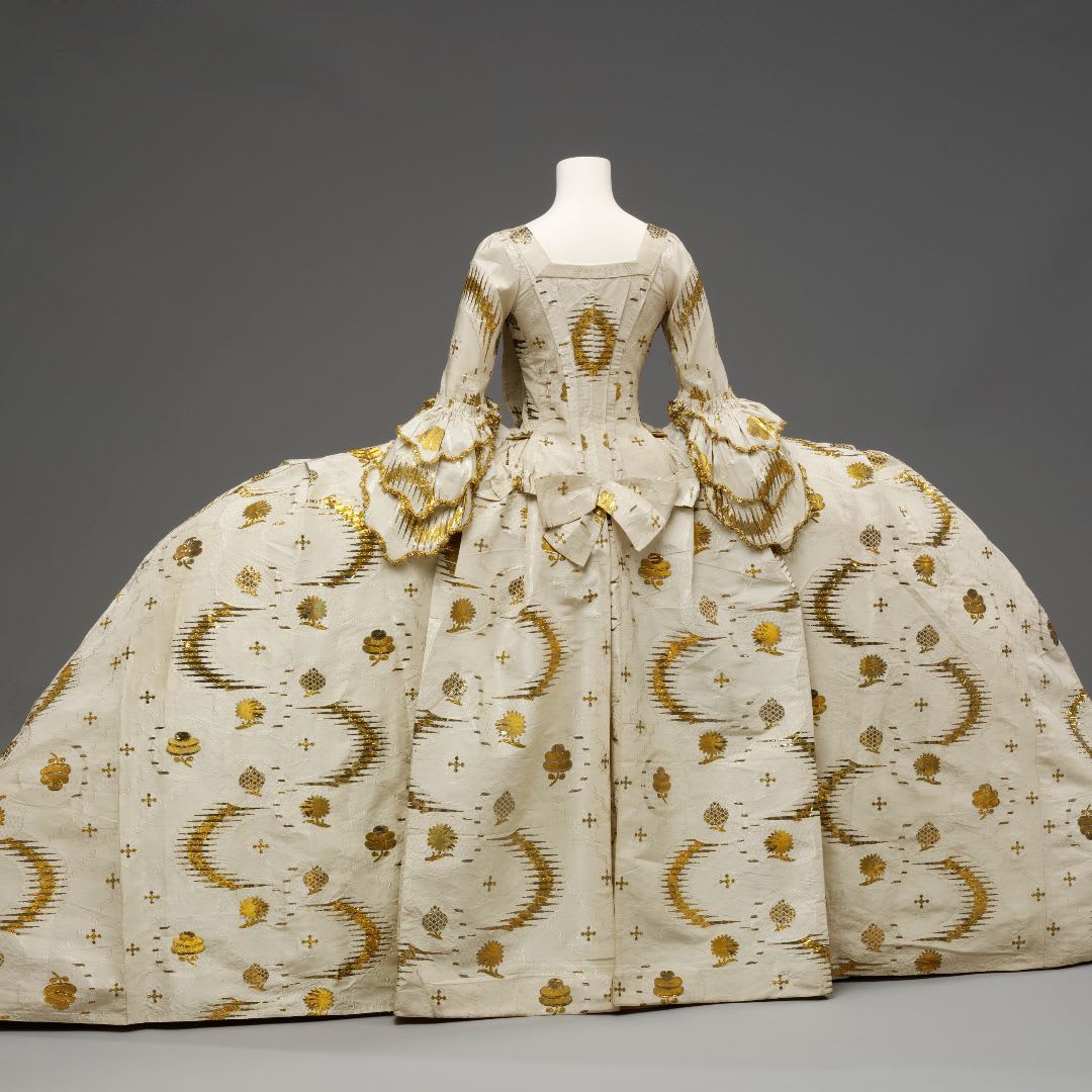 This richly brocaded ensemble illustrates the style of dress worn by women at court in England. Known as a mantua, the gown consists of a bodice with a train at the back. Can you believe that in the 18th century this was considered as stylish day wear?