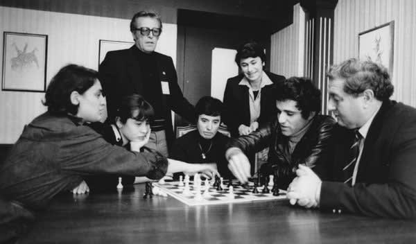 Lucerne Chess Olympiad in 1982 - Garry Kasparov analyses a game with Maia Chiburdanidze. Nana Alexandria, Nana Ioseliani, Nona Gaprindashvili, Aivars Gipslis and Eduard Gufeld look on.