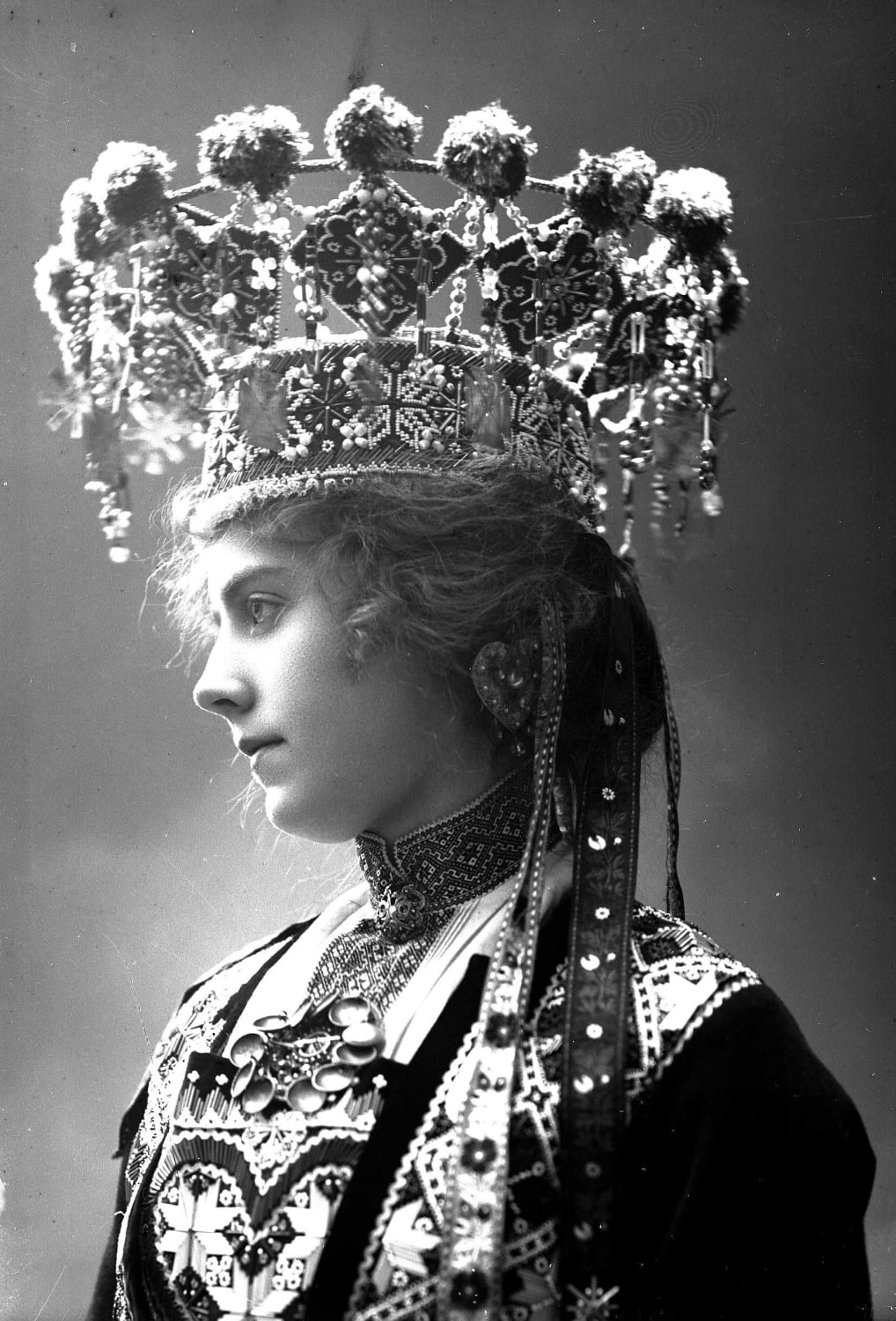 Studio photograph of a Norwegian woman in a wedding dress and bridal crown from Hordaland, 1890's. taken by Sloveig Lund