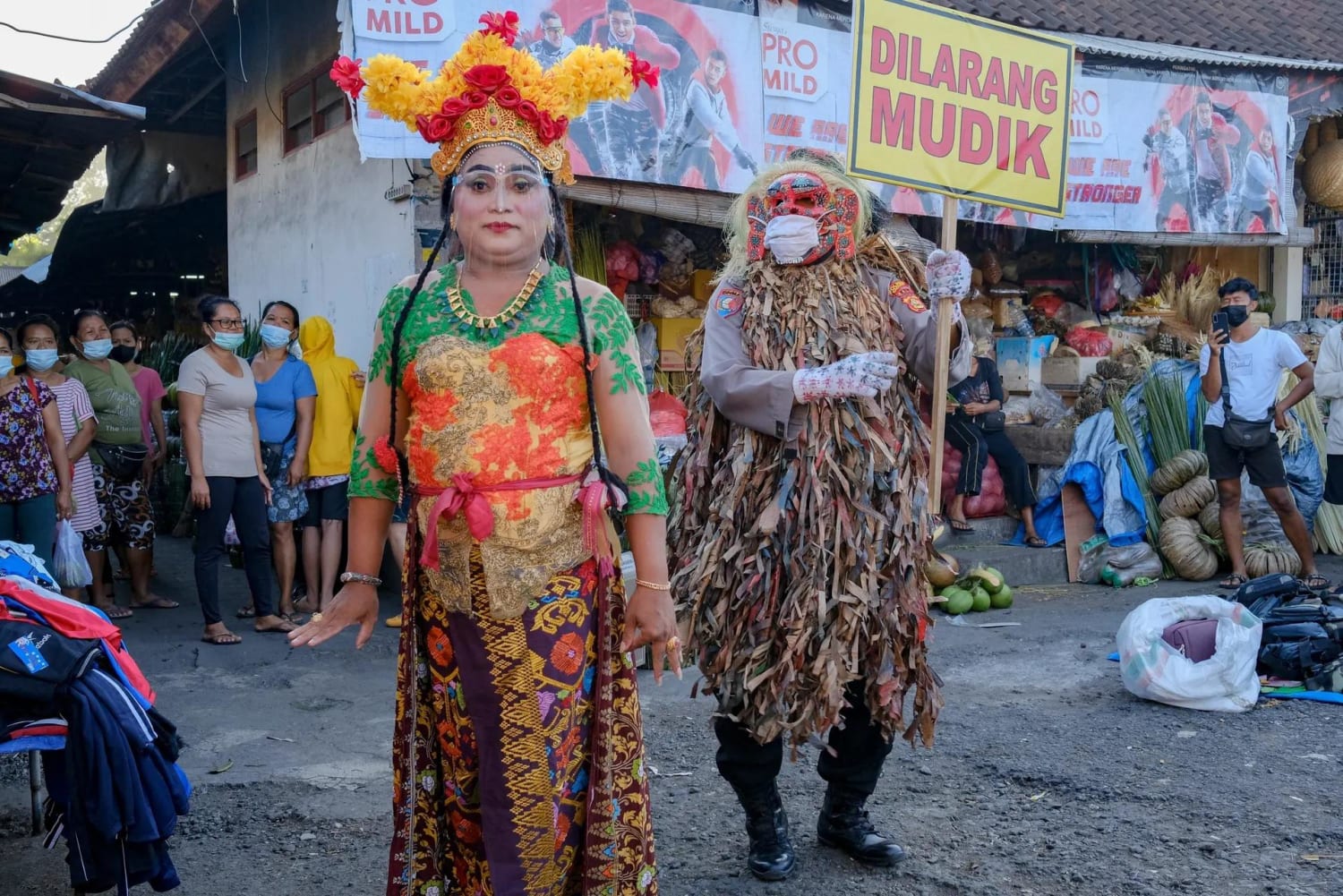 A police officer and a traditional dancer educate people on how to prevent the spread of Covid-19 in Bali, Indonesia. Photograph: Made Nagi/EPA