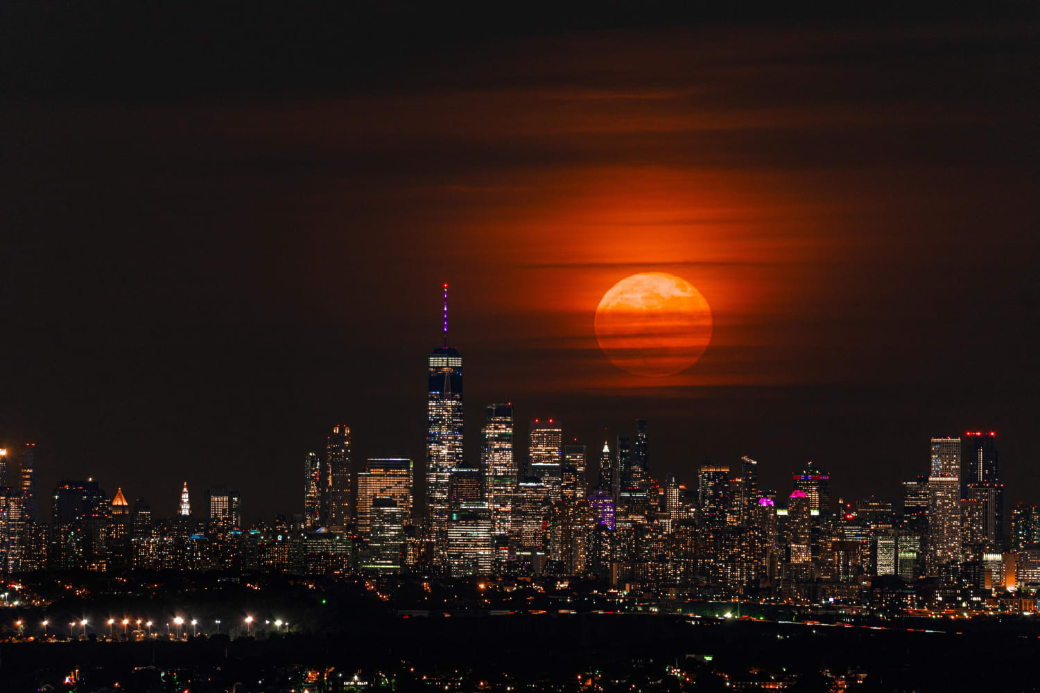 Been seeing a lot of mooning on this sub the last day, can't help but show you mine ;) This is the supermoon from last night, shot from 13.6 miles away from New York City! (credit @mikeyyy0)