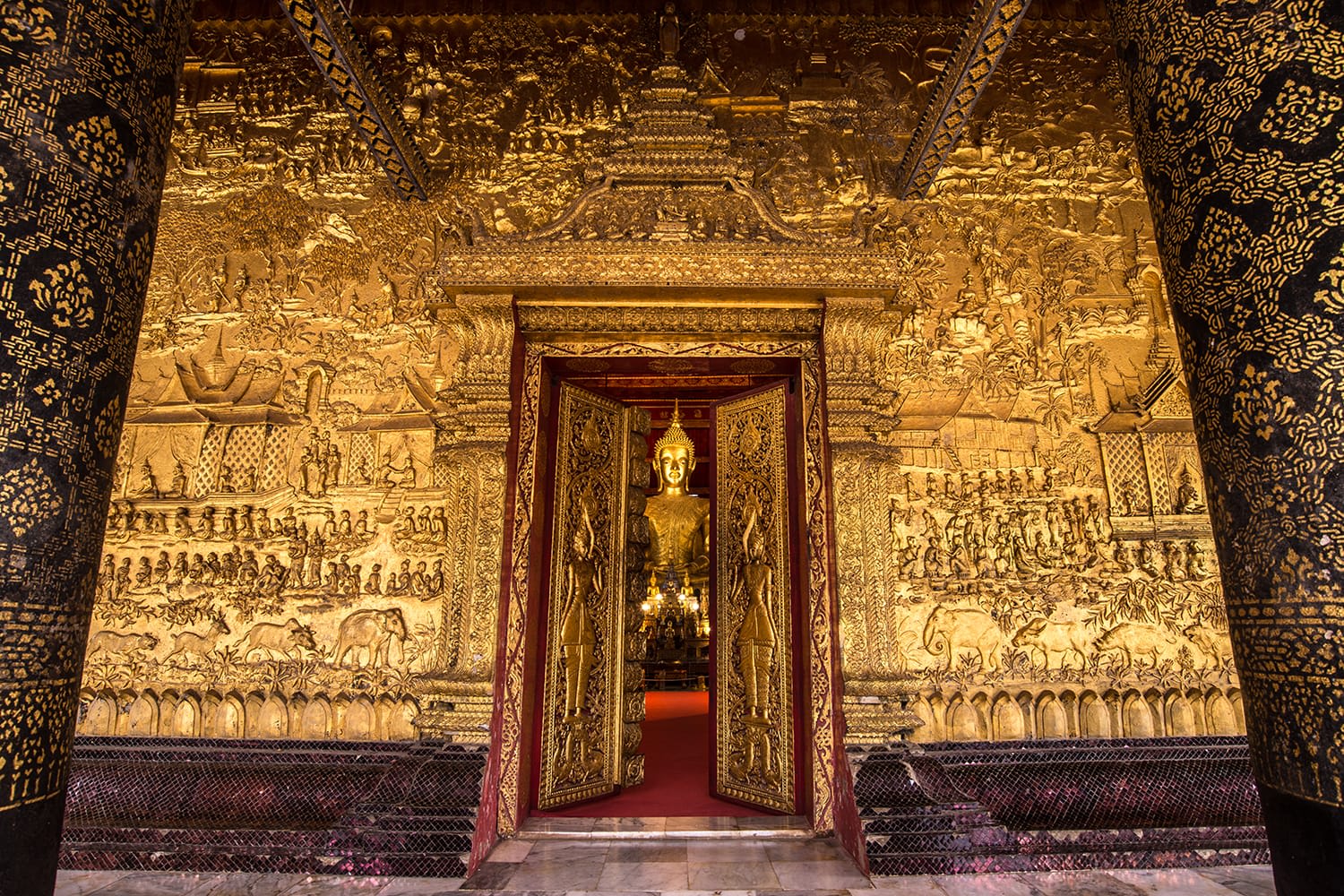 Gilded reliefs and golden door of Wat Mai Suwannaphumaham, an 18th-century Buddhist temple in Luang Prabang, Laos
