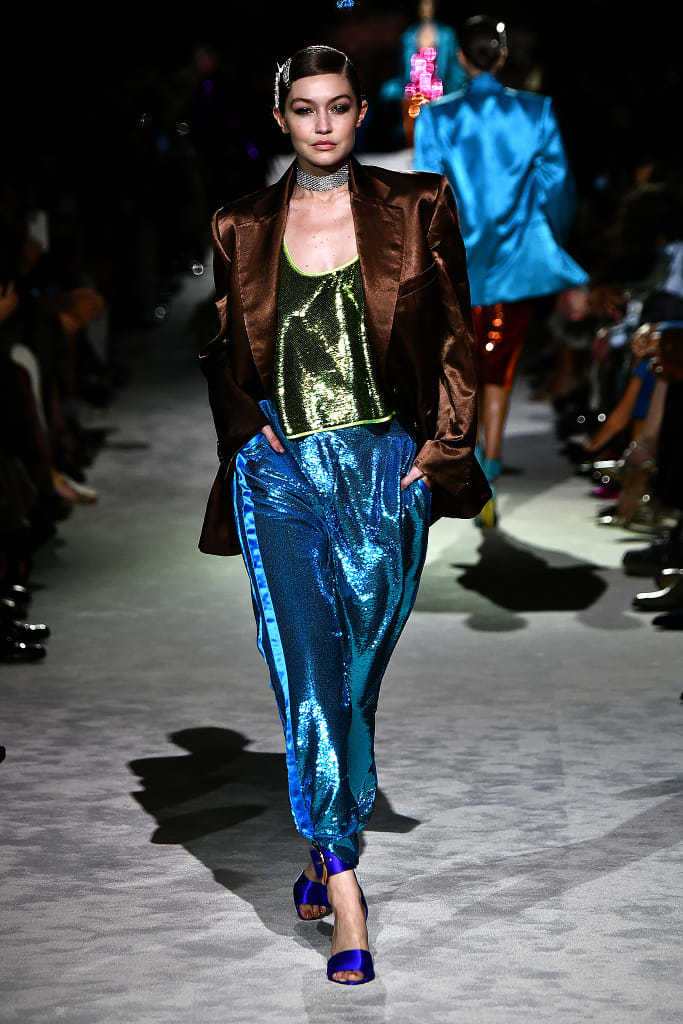@TomFord threw it back to the 1990s for spring with glam athleticwear, logo bra tops and gold chains galore.