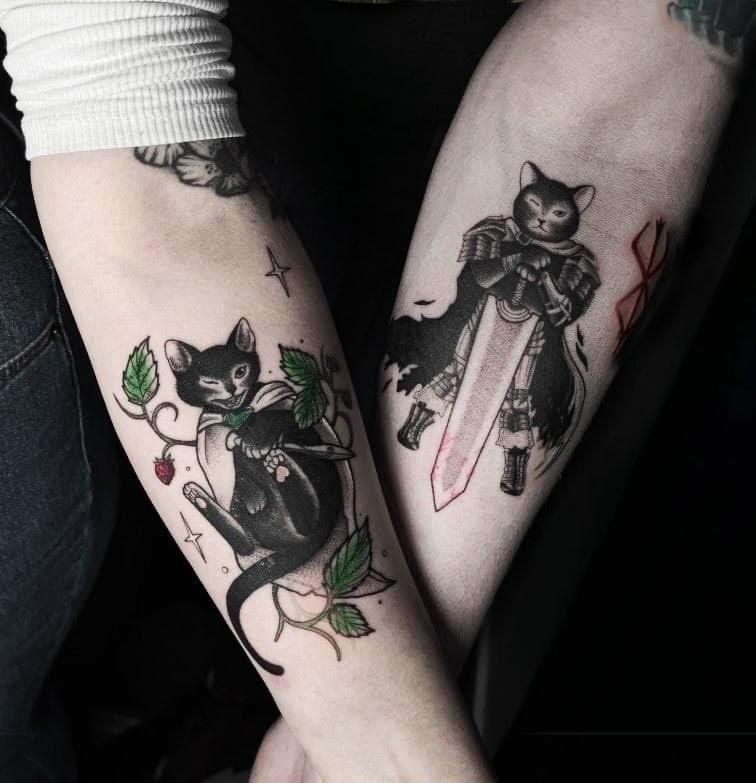 Matching couple's tattoo - our cat as a hobbit (LOTR) and Guts (Berserk) by Dani at Ink Unit Studio, Klaipėda, Lithuania