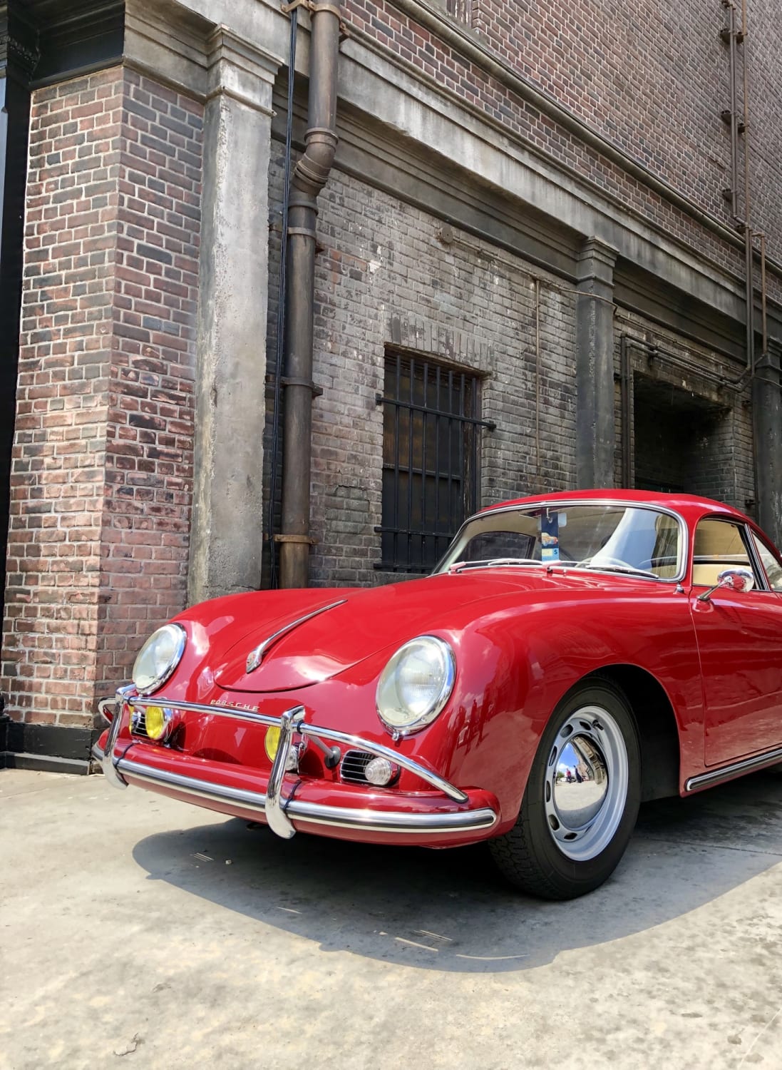 Porsche 356 peering out of an alley