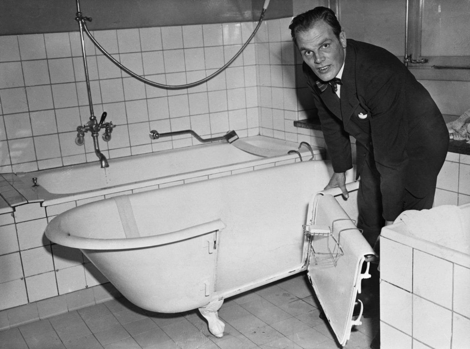 Per Bergmann proudly introducing his latest invention, which was intended to make it easier for old and disabled people to get in and out of the bathtub. Sadly for Per, having a door on a bathtub proved very leaky. Sweden, 1953.