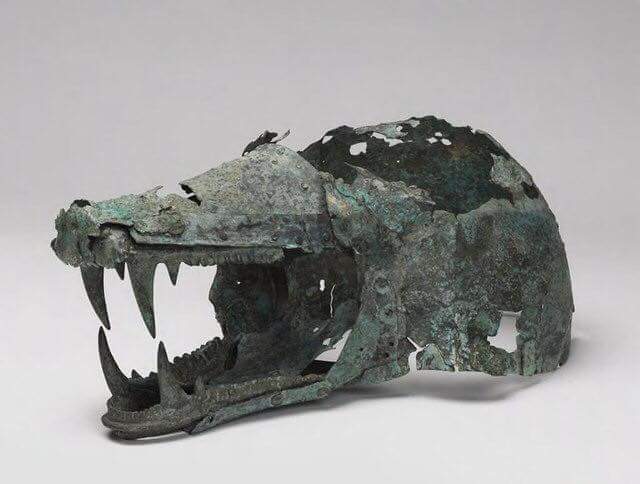 Etruscan helmet in the shape of a wolf’s head. The object is made of bronze and dates back to the 6th-5th centuries BCE.