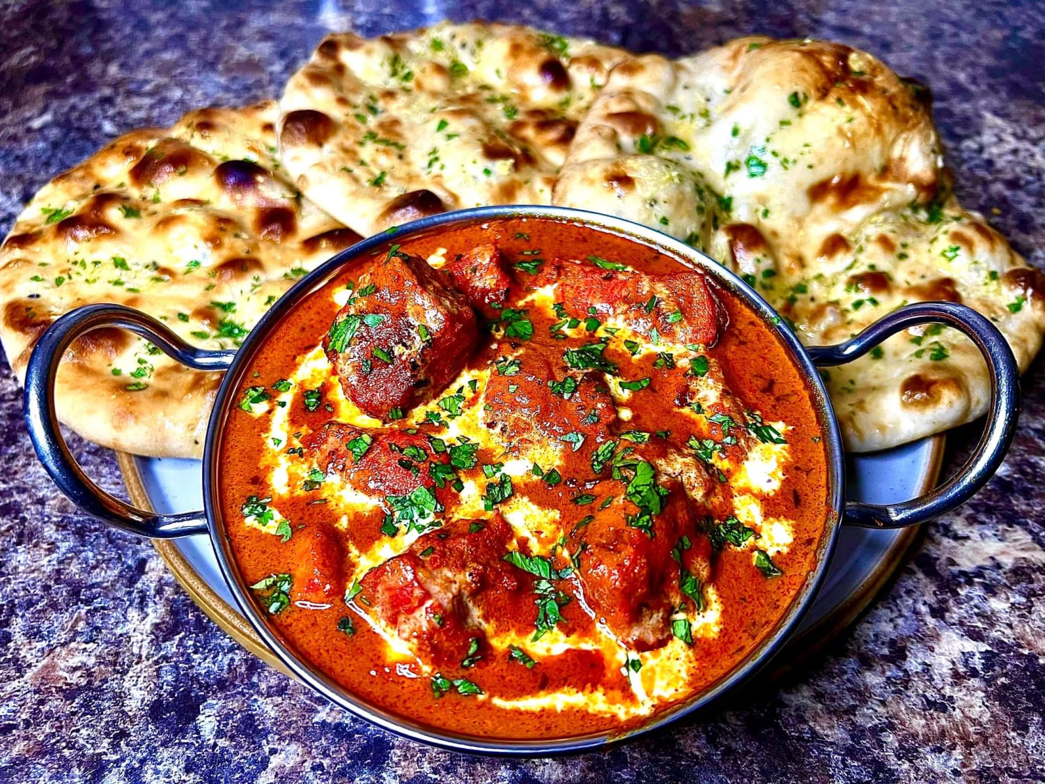 Chicken tikka masala with garlic and coriander naans. All made from scratch.
