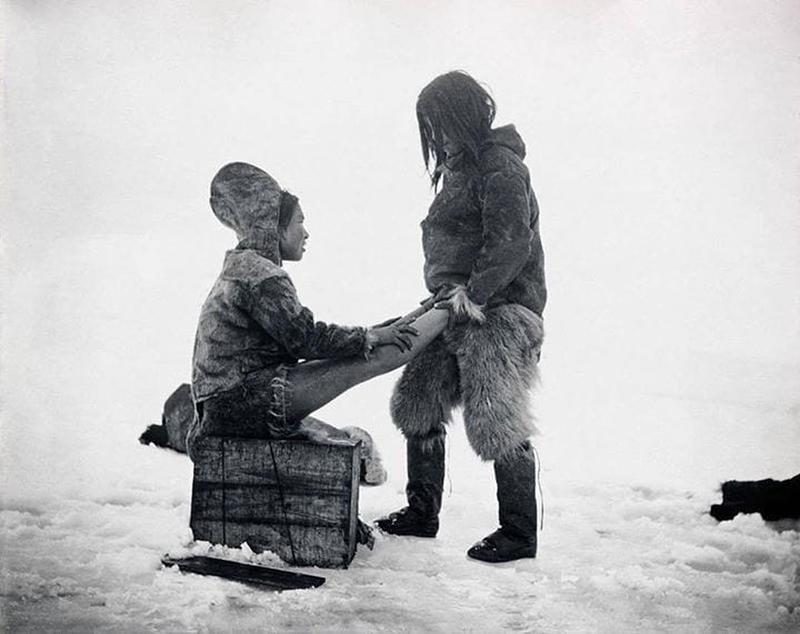 An Inuit man warms up his wife’s feet in Greenland, 1890's. Photo by Robert E. Peary.