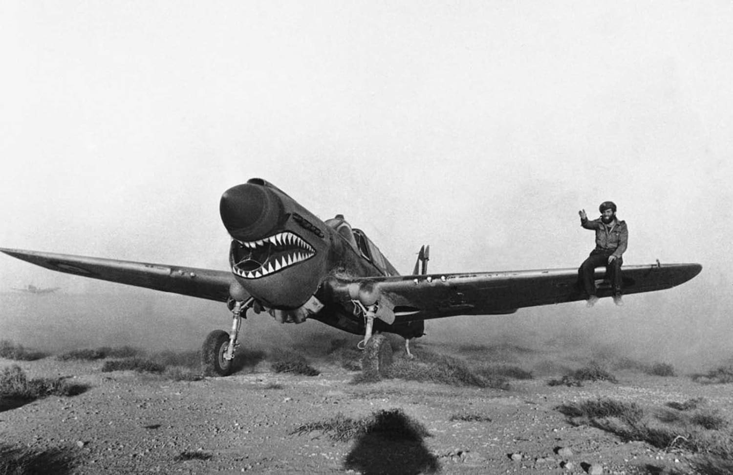 Experienced in desert weather flying, a British pilot lands an American made Kittyhawk fighter plane of the Sharknose Squadron in a Libyan Sandstorm, on April 2, 1942. A mechanic on the wing helps to guide the pilot as he taxis through the storm.