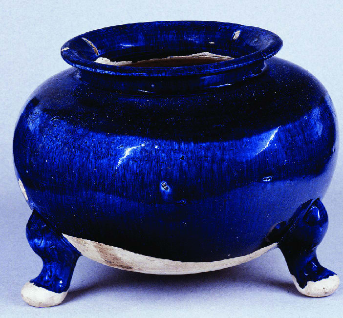 A glazed earthenware tripod vessel, made in the Henan province in China, during the Tang dynasty (618-906 CE). Height 16.5 cm, now housed at the Benaki Museum in Athens