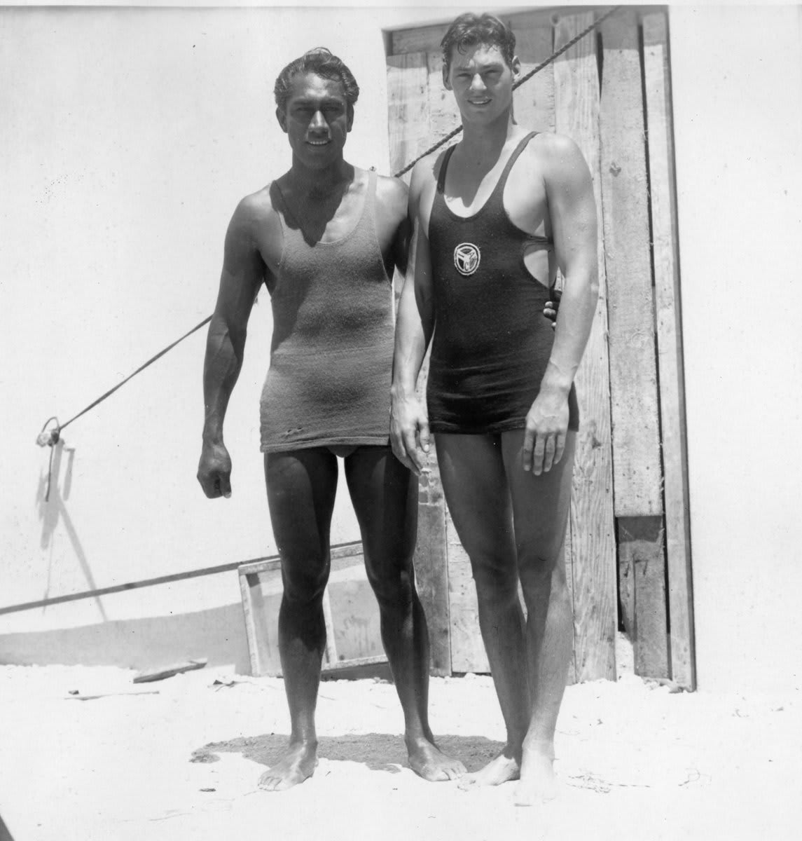 It was a whole vibe on Waikiki Beach in 1927 when water sports legends Duke Kahanamoku and Johnny Weissmuller–also known as the Big Kahuna and Tarzan–posed together.