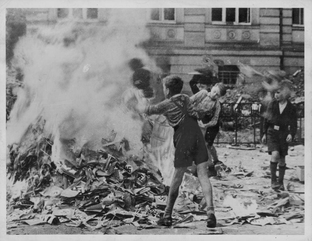 German children burning Nazi symbols in 1945