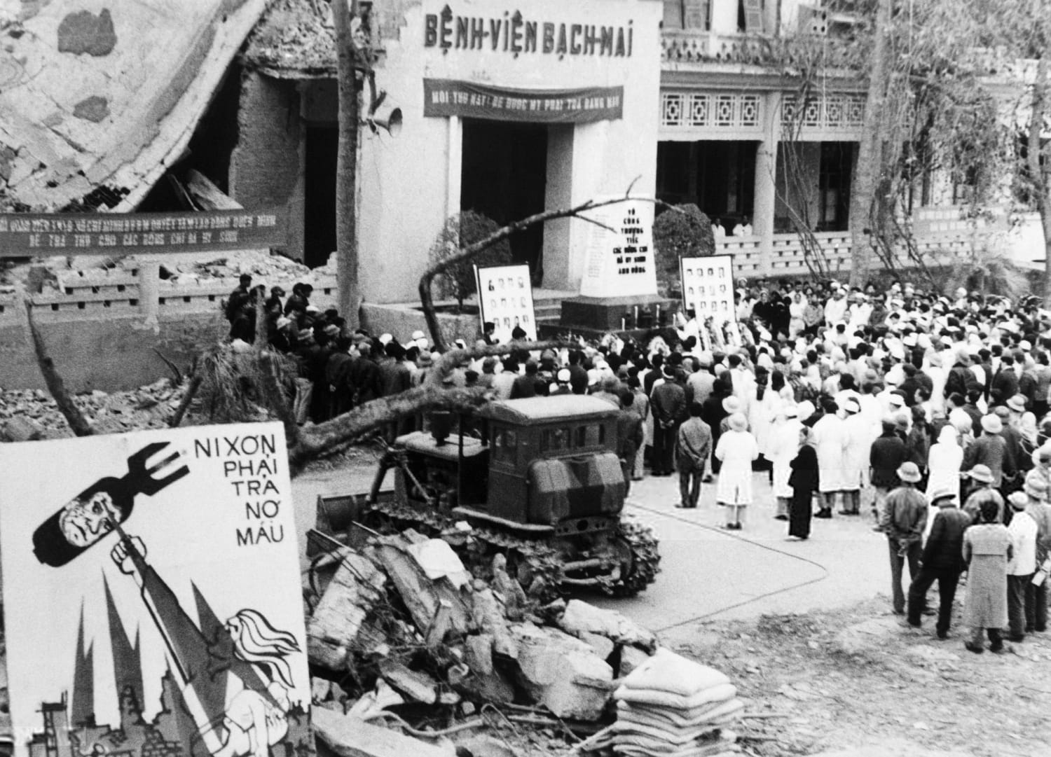 Jan 09 1973, Bach-Mai Hospital, Hanoi, North Vietnam - Funeral services are held at Bach-Mai Hospital in Hanoi, North Vietnam for the hospital staff killed by US B-52 bombing runs on Dec 19-20 1972. An anti-Nixon poster is displayed near the wreckage.