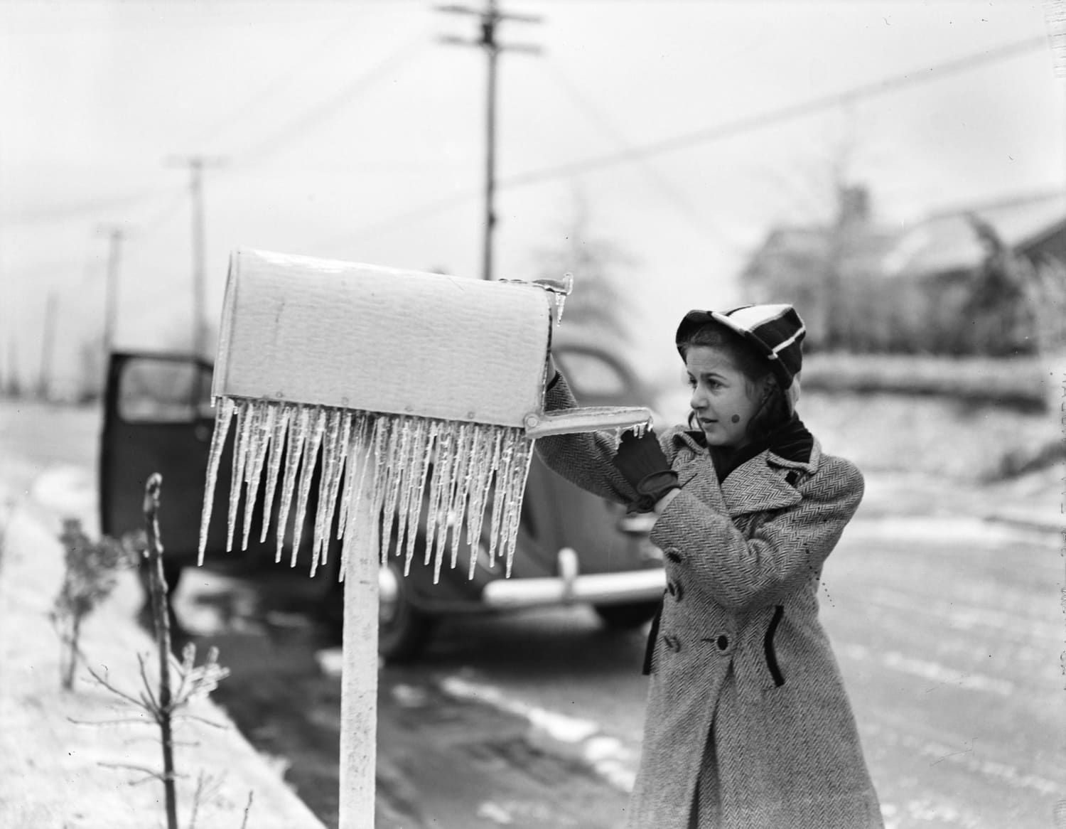 Checking the mailbox after an ice storm in Atlanta, 1940