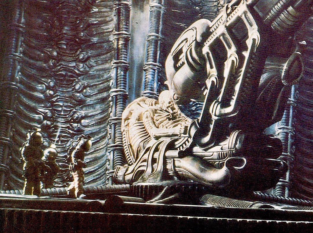 ‘Space jockey’ scene from Alien (1979). If I’m not wrong it’s kids in those space suits, used to create a greater sense of scale