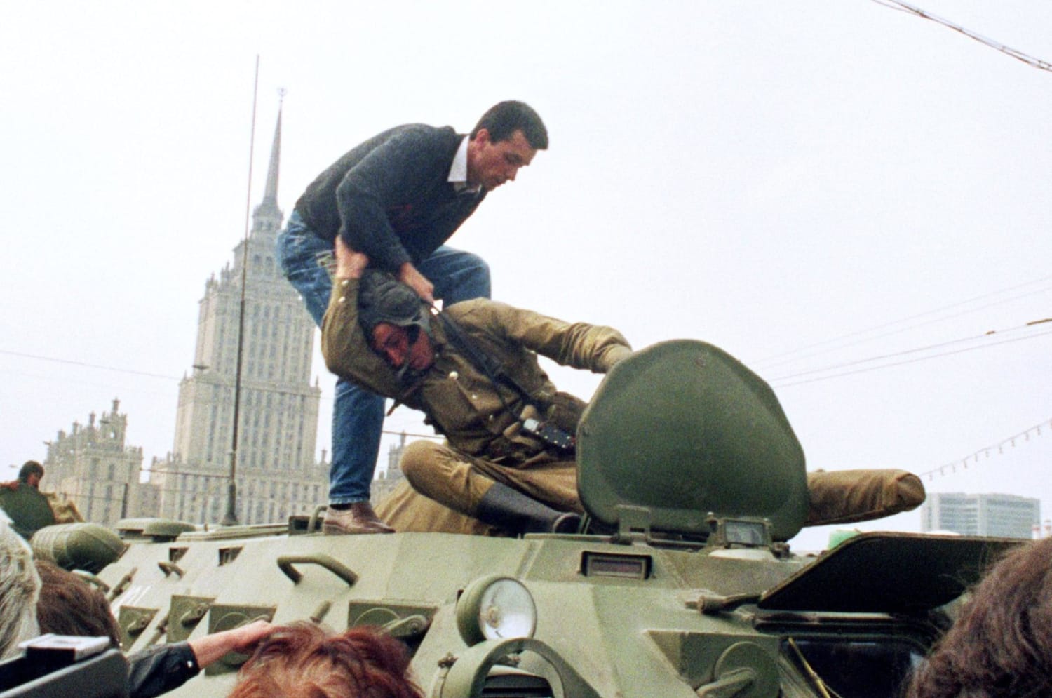 On August 19, 1991, a pro-democracy demonstrator fights with a Soviet soldier on top of a tank parked in front of the Russian Federation building after a coup toppled Soviet President Mikhail Gorbachev.