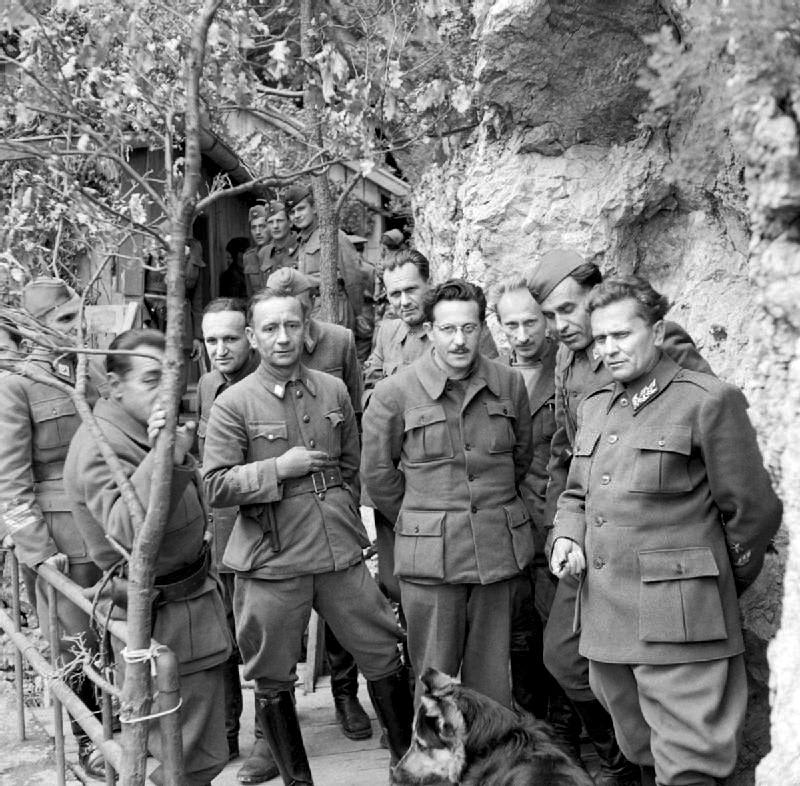 Marshal Tito stands with his Cabinet Ministers and Supreme Staff at his mountain headquarters in Yugoslavia on 14 May 1944. (See comment)