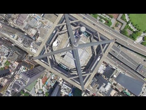 Drone Films Daredevils at Peak of Hong Kong Skyscraper