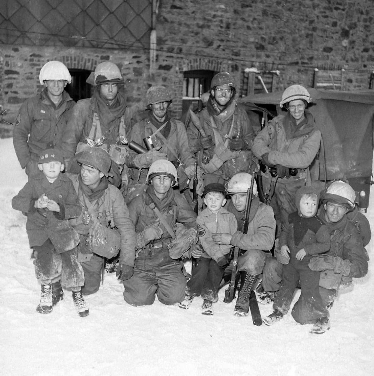 GIs with local children near Bütgenbach Belgium, January 1945. LIFE Magazine Archives - George Silk Photographer