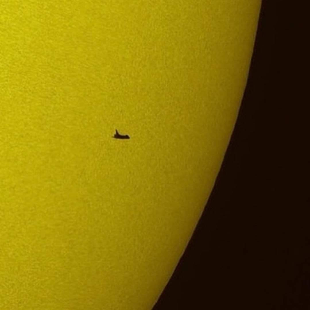 The NASA space shuttle Atlantis is seen in silhouette during solar transit, Tuesday, May 12, 2009, from Florida. This image was made before Atlantis and the crew of STS-125 had grappled the Hubble Space Telescope