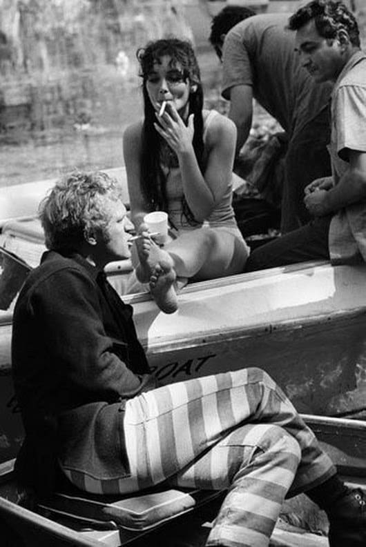 Suzanne Pleshette, passing Steve McQueen a cigarette with her foot on the set of Nevada Smith-1966.
