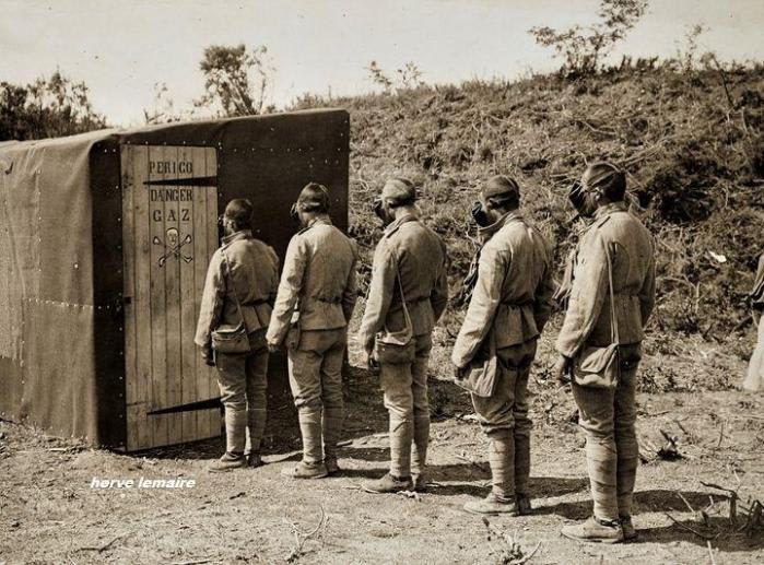 Portuguese soldiers wait their turn to test their physical and moral resistance under the effects of gas in a sealed practice chamber, 1914-18.