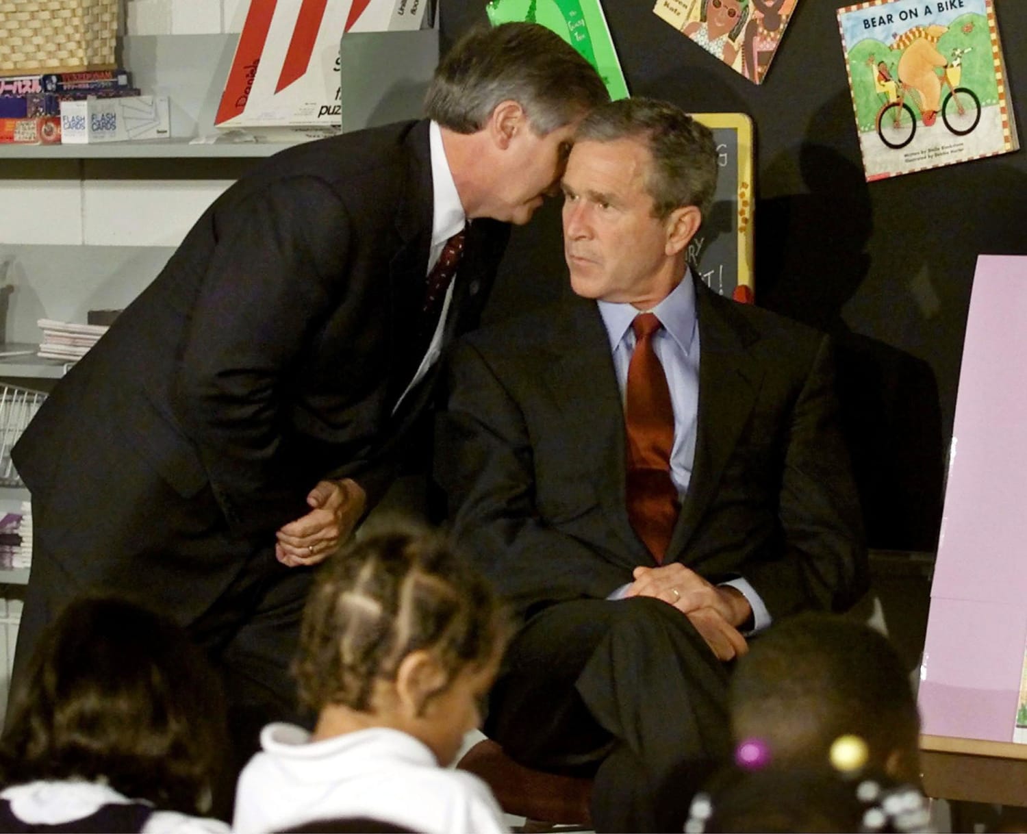 Chief of Staff Andy Card whispers into the ear of President George W. Bush to give him word of the plane crashes into the World Trade Center, during a visit to the Emma E. Booker Elementary School in Sarasota. Tuesday, Sept. 11, 2001.