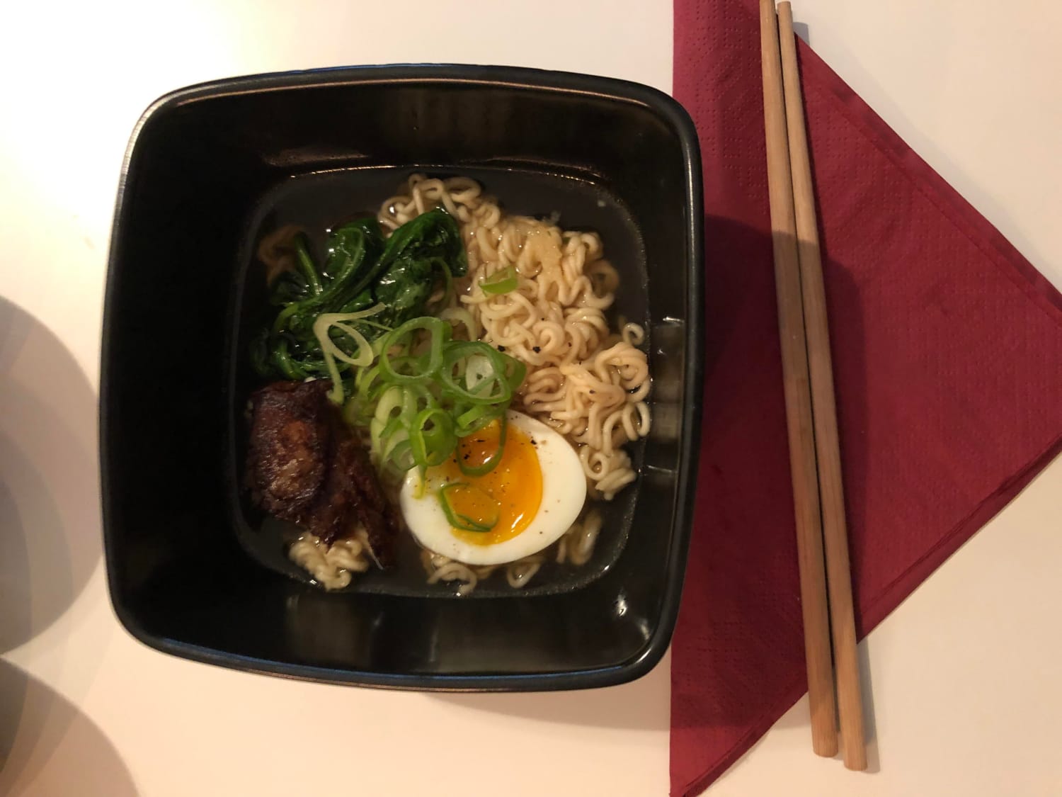 Instant chicken ramen with spinach, spring onions, shoyu, sesame oil, soft boiled egg and grated garlic