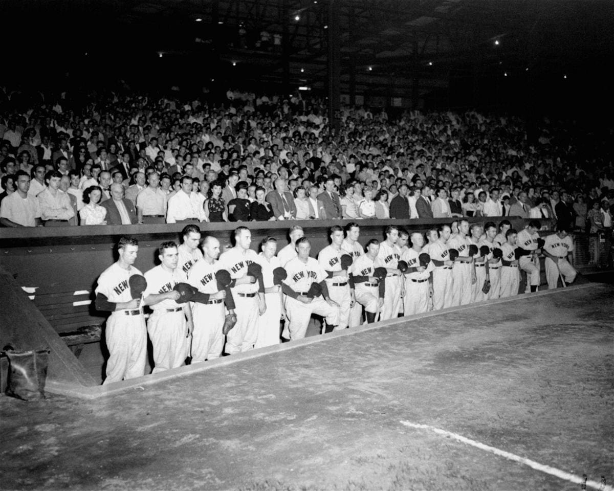 New York Yankees' players stand in the dugout at Yankee Stadium, NY, in silent tribute after the announcement of Babe Ruth's death, August 16, 1948 AP Photo-Ron Howard.