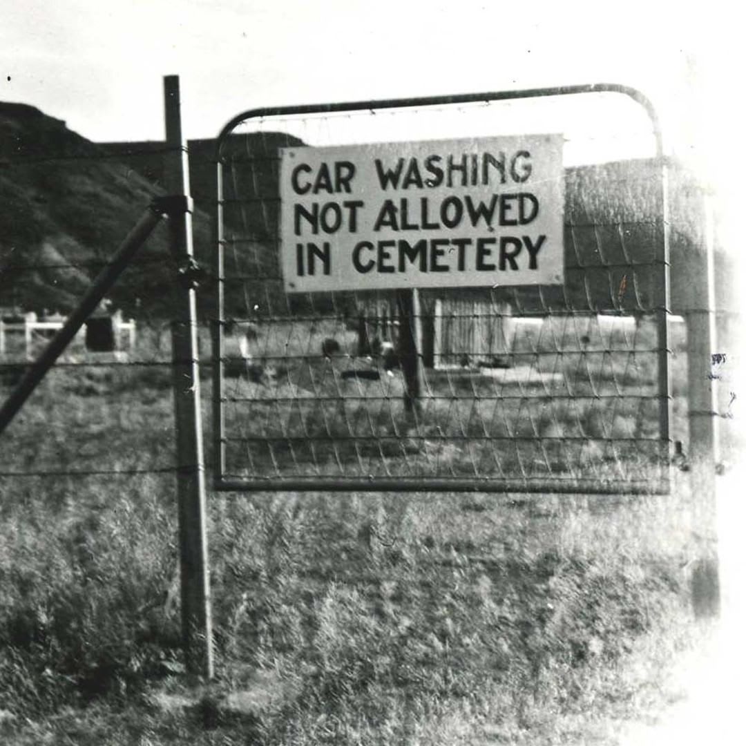 A curious warning sign placed at the entrance of a cemetery in Goldfield, Nevada, early 1900s.