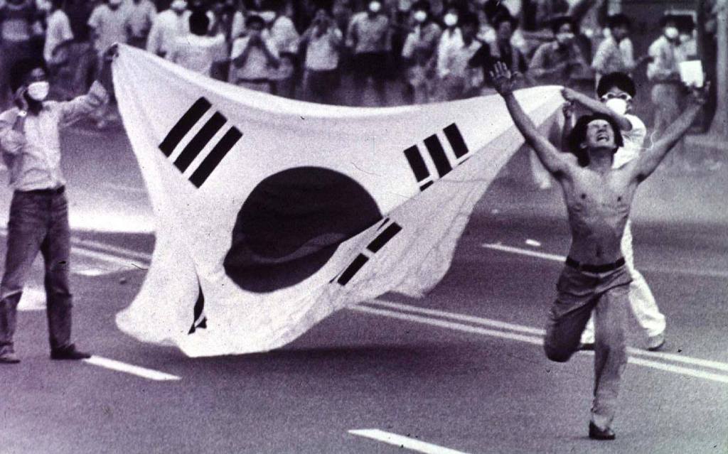 Protestors rush towards the police firing tear gas in Busan, South Korea, during demonstrations as part of the nationwide democracy movement against the military regime of South Korean President Chun Doo-hwan - 1987