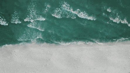 Aerial view of waves on a sandy beach