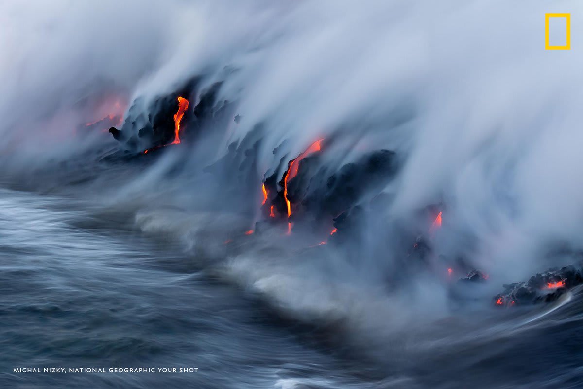 This dramatic moment of lava flowing into the Pacific Ocean from Kalapana, Hawaii was captured by YourShotPhotographer Michal Nizky.