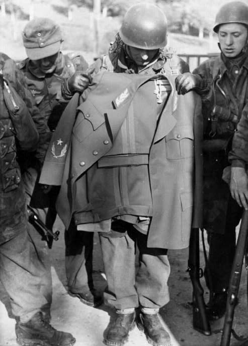 Having narrowly failed to capture the Yugoslav partisan leader during Operation Knight’s Move, these German Waffen-SS paratroopers hold up Tito’s captured uniform, 1944
