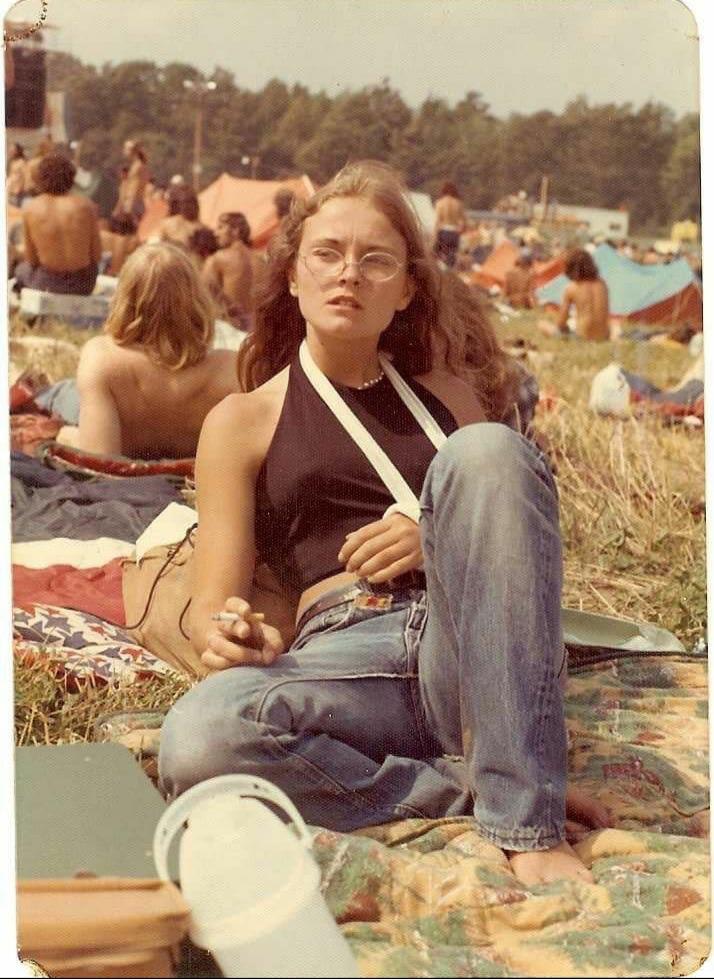 A teenager smoking at an Allman Brothers concert with a broken arm. Watkins Glen, 1973.