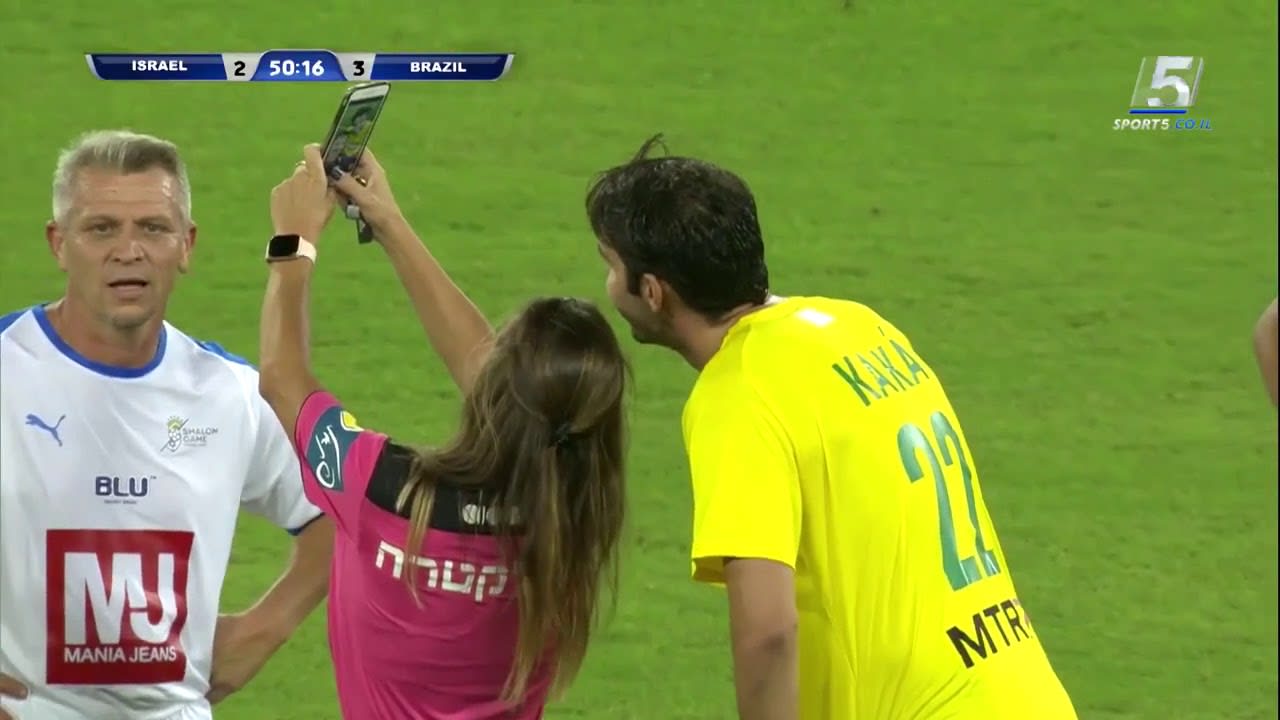 The guy on the left as ref gives Kaká a yellow card, then takes a selfie.
