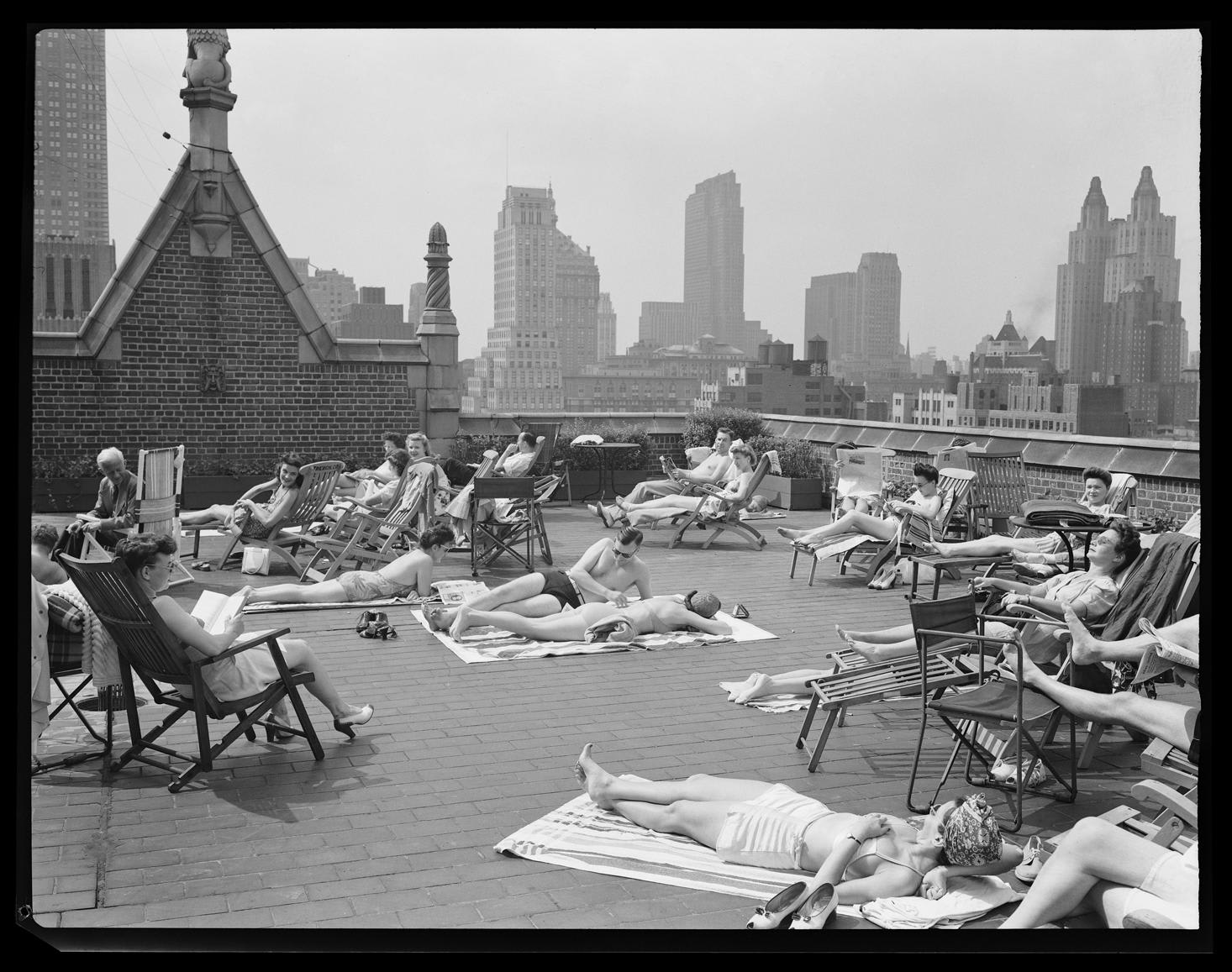 Sunbathing on the roof of an apartment building in Tudor City, New York, 1943.