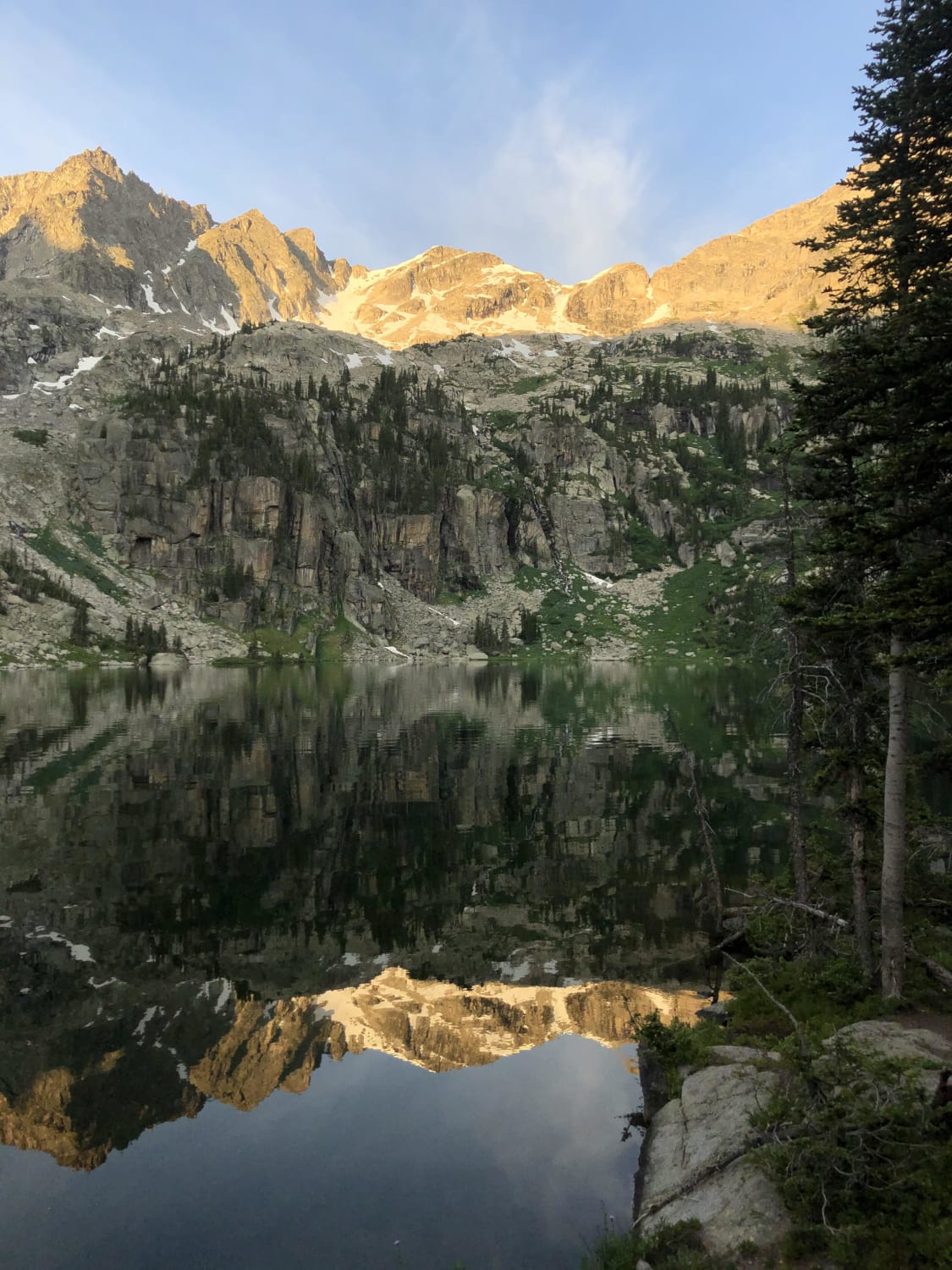 The reflection on Crater Lake at sunrise inside Colorado’s Indian Peaks Wilderness Area