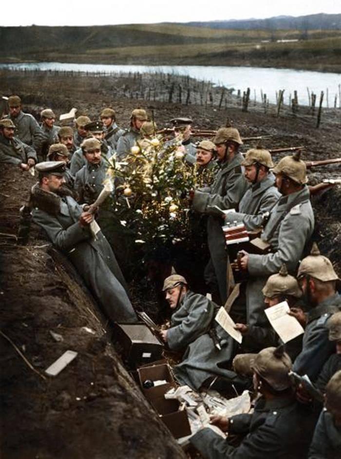 German troops singing around a Christmas tree in their trench on the Eastern Front during World War I, circa 1915. (Colorized, link to original Bg&W photo in comments)
