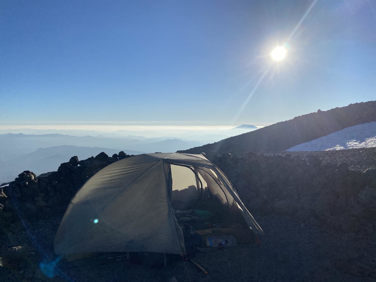 Climbed up and stayed the night at Lunch Counter (9,400 ft) on Mt. Adams. The mountain you can peaking over the clouds is Mt. Saint Helens.