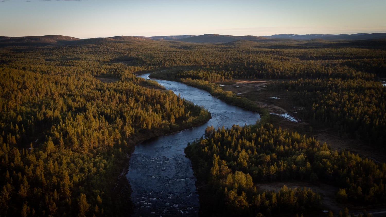 A river called 'Kielajoki' flowing through Muotkatunturi Wilderness Area in Lapland, Finland at 00:30am. This is as dark as it gets until 25th of July, when sun will be setting the next time.