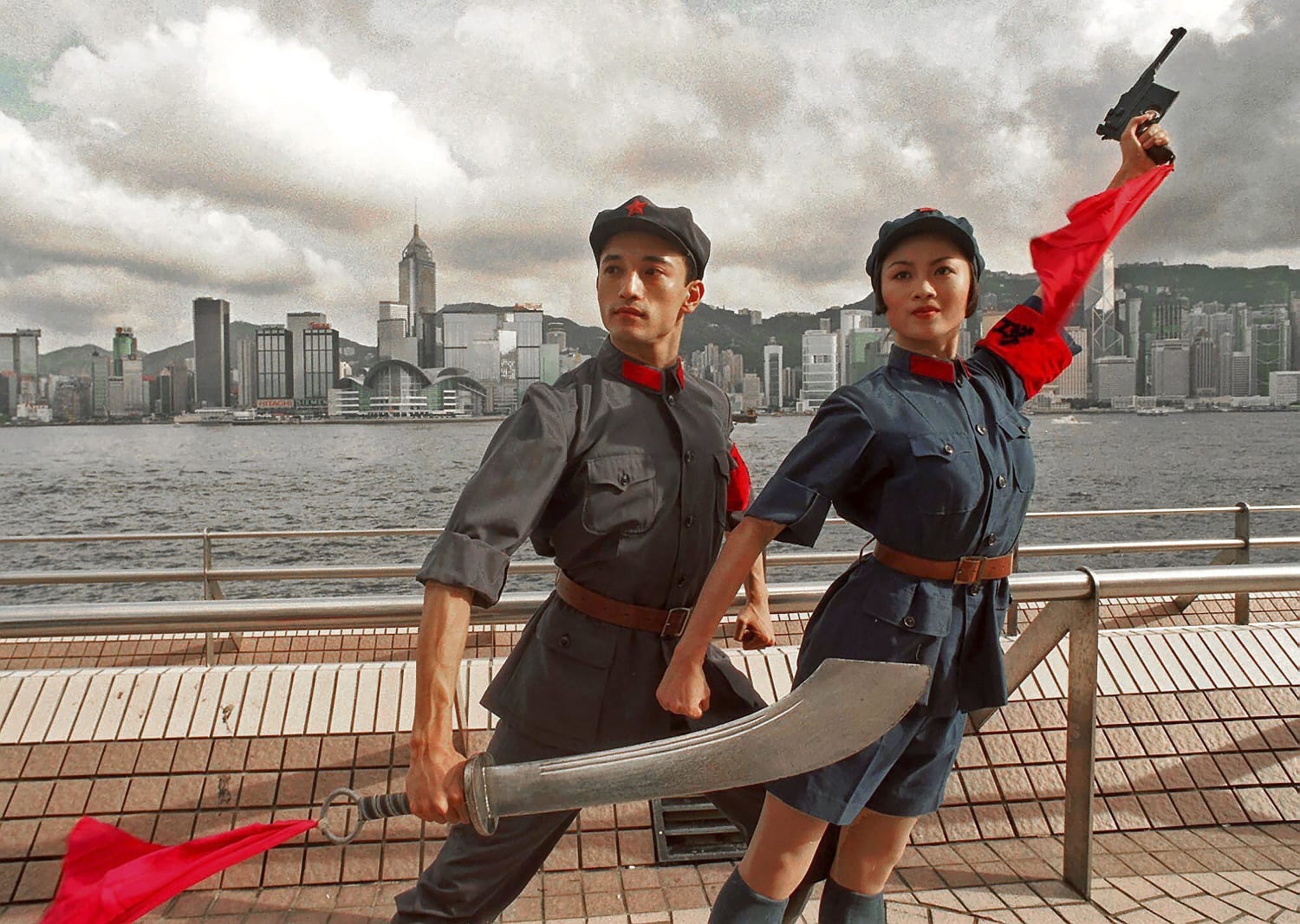 July 21, 1998, file photo, dancers of China's National Ballet, Sun Jie, left, and Zou Zhi Rui, dressed in military uniforms pose for photographers at Hong Kong's waterfront. A year after Beijing imposed a harsh national security law on Hong Kong, ... (More, below)