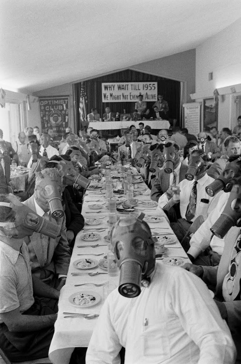 Highland Park Optimist Club wearing smog-gas masks at banquet, in the Highland Park district, Northeast Los Angeles - ca. 1954