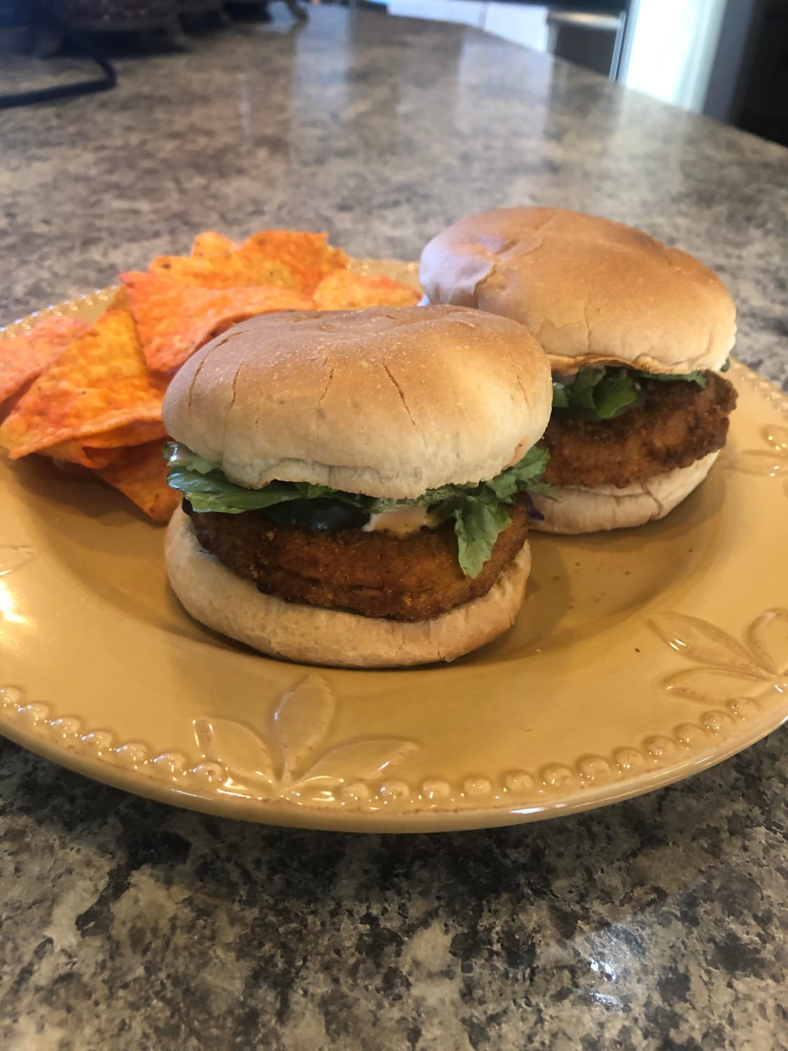 Air-fryer chicken patties, sriracha mayo, pickles, and chopped romaine on toasted Rotella buns.
