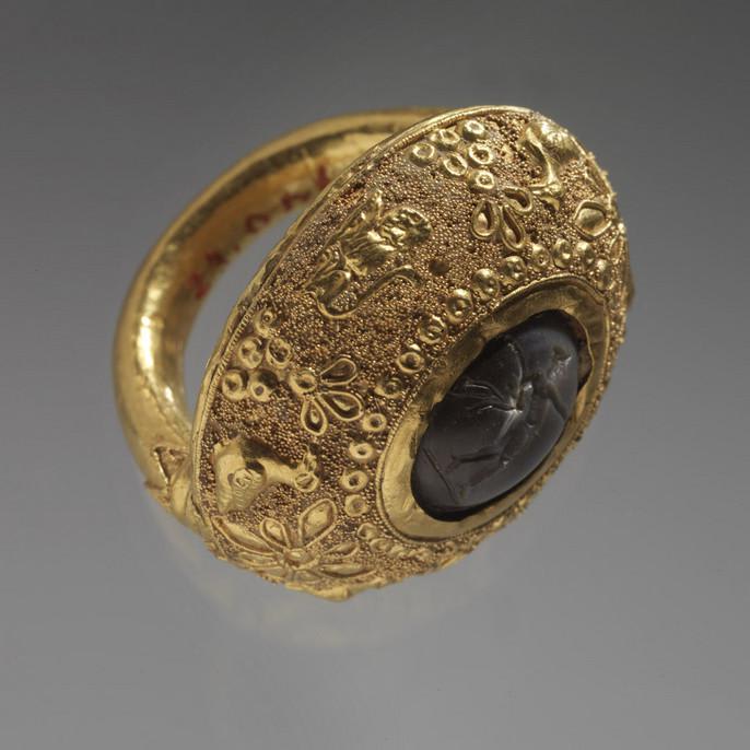 A delicately engraved Etruscan gold ring with a milky grey stone. Crafted in Tuscany ca. 400-200 BC. RISD Museum.